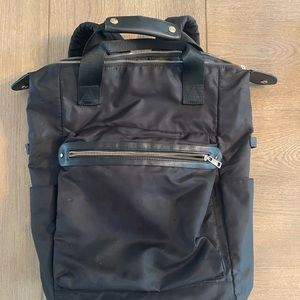 A new day black backpack with gold zipper